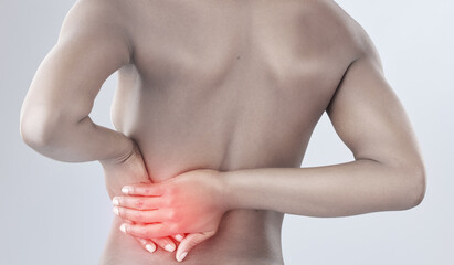 Woman, back pain and injury with inflammation from tension, sore muscle or accident on a white...