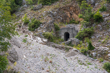 Old tunnel opening in the countryside mountains of Albania