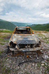 Burned car in the mountains of North Albania