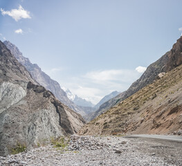Highway highway in the mountains of Tajikistan on a sunny summer day, road in the highlands
