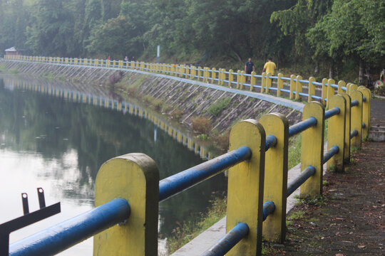 Yogyakarta, Indonesia - 01 May 2024: Tambakboyo Reservoir is a sunken area of land that is used to store water. Around the embung there are usually lots of people jogging in the morning.