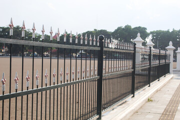 Yogyakarta, Indonesia May 4 2024: Iron fence surrounding Alun Alun Lor or North of the Yogyakarta Palace. People cannot carry out activities in this square.