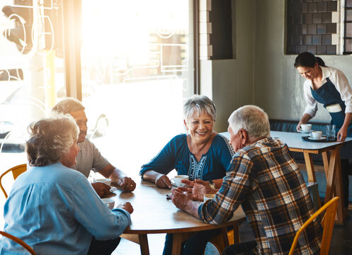 Senior, friends and group relax at cafe on holiday or reunion on vacation in retirement. Elderly, people and talking at coffee shop with gossip, story or funny rumor in community chat in morning - Powered by Adobe