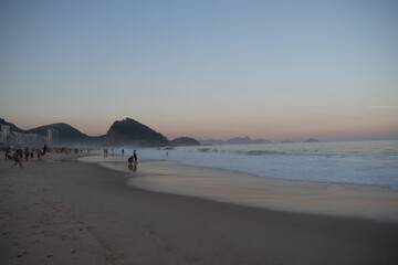 people leisurely enjoying the beach after sun down