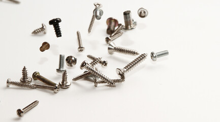 Stainless steel flat head sharp end screw on white background