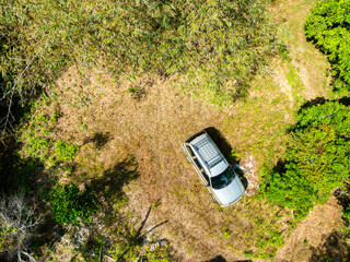 Top view Brown American SUV Jeep Grand Cherokee WJ 2002 on the dirt road in Phuket Thailand,Off-road in the forests