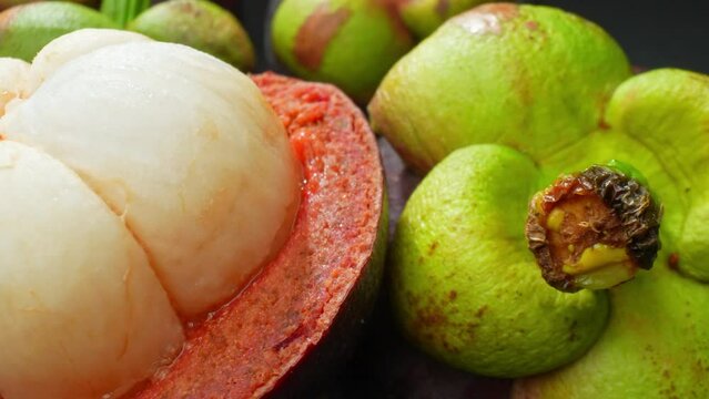 Gaze upon the lush purple rind and succulent, ivory flesh of the mangosteen, a tropical gem. Its intricate textures and vibrant hues evoke a sense of exotic allure, inviting a taste of paradise.
