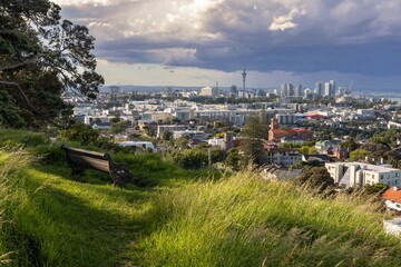 Park bench with a view over New Market to downtown Auckland from Mt Hobson, Auckland, New Zealand.
