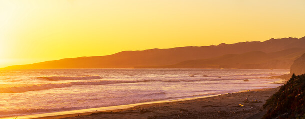 Sunset over ocean at dawn, dusk at ocean, beach