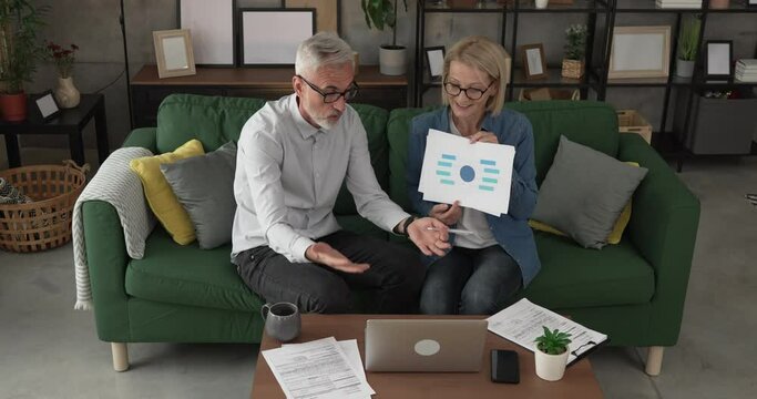 Mature man and woman work form home have consultation via video call