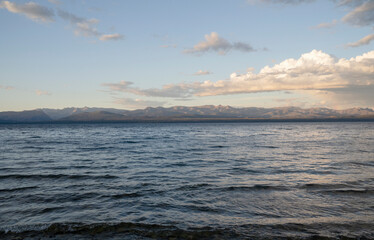 View of the calm lake and mountains in the horizon at sunset