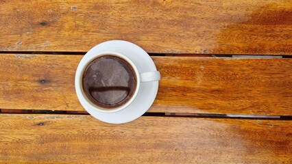 Close-up cup of coffee on wooden table