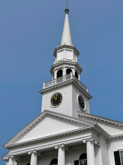 Closeup of a steeple of a white New England church,