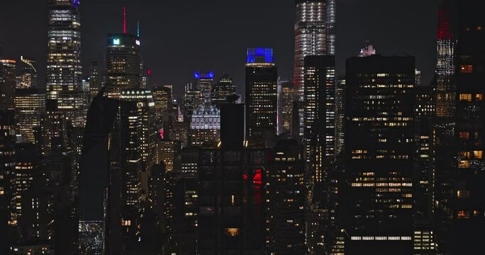 NYC New York Aerial v174 tracking shot flyover East river capturing electric atmosphere of illuminated Midtown Manhattan skyscrapers cityscape at dark night - Shot with Inspire 3 8k - September 2023