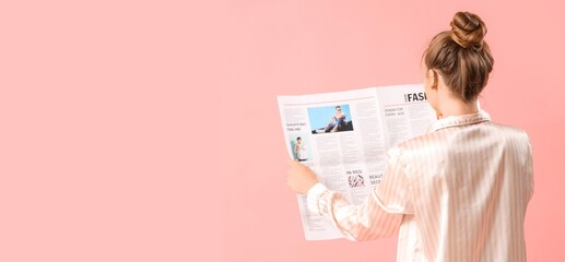 Young woman in pajamas reading newspaper on pink background with space for text