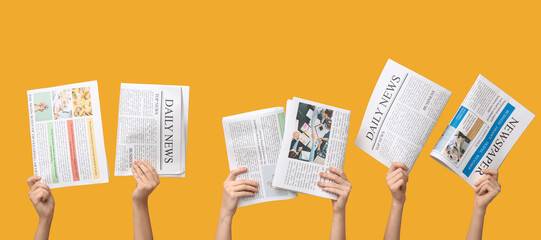Women with newspapers on yellow background