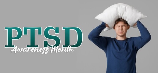 Stressed young man with pillow on grey background. Post-Traumatic Stress Disorder Awareness Month
