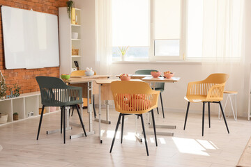Interior of kindergarten with breakfast on tables