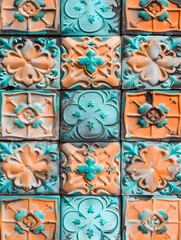 Obraz premium A colorful tile pattern with a blue and orange flower design. The tiles are arranged in a grid, with each tile having a different color and design. The overall effect is a vibrant