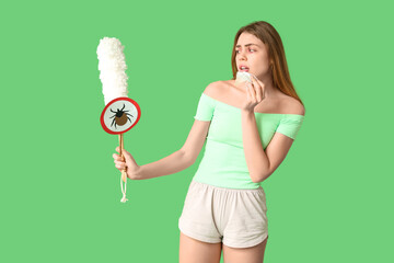 Woman with pp-duster, mite sign and tissue suffering from allergy on green background