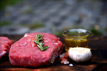 Raw meat beef steak organic fresh ingredient on wooden board table background in kitchen with...