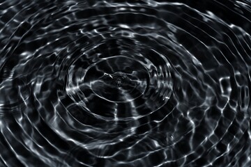 Black water with ripples on the surface. Defocus blurred transparent blue colored clear calm water...