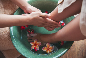 Massage Thai Spa foot massage flower oil therapy. Close up woman foot therapy relax treatment...