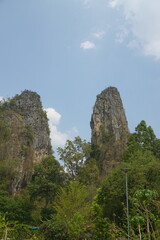 Two large mountains are in the background with a clear blue sky