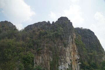 A mountain range with a cloudy sky in the background