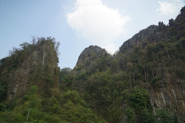 A mountain range with a cloudy sky in the background