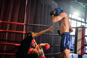 Two young professional boxer having a competition tournament on stage. 