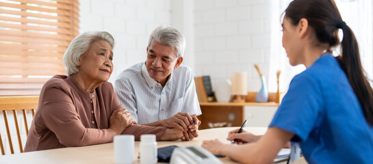 Asian caregiver nurse examine senior man and woman patient at home. 