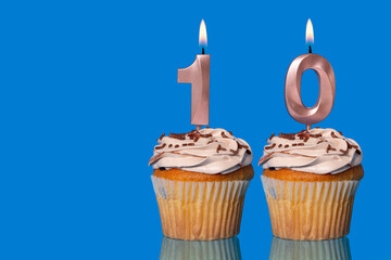 Birthday Cupcakes With Candles Lit Forming The Number 10.
