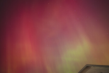 aurora australis or southern lights visible from Tasmania's clear night sky full of stars and...