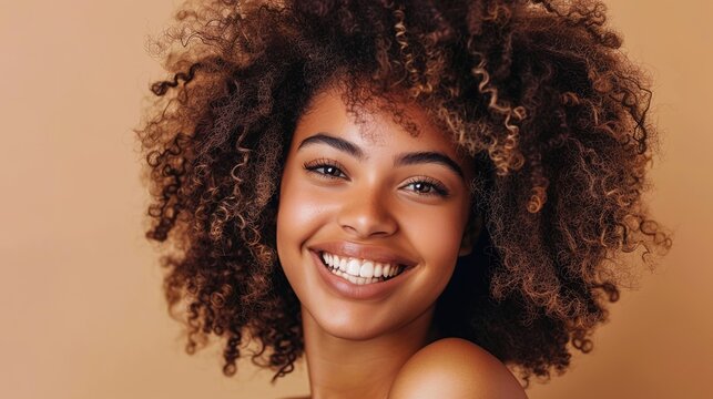 Natural curls framing a smiling face, embracing the beauty of textured hair. 