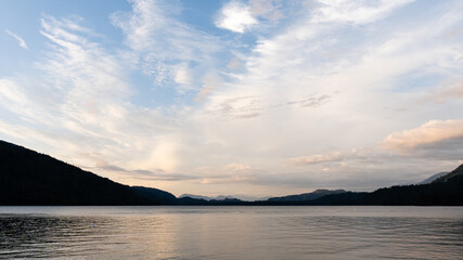after noon on mountain lake with calm water and cloudy sky