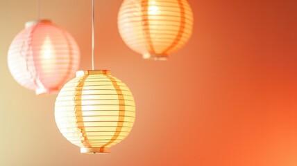 Hanging paper lanterns illuminated against orange background - Powered by Adobe