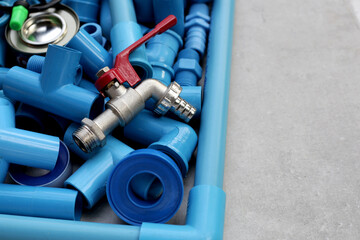 Plumber equipment with blue pvc pipe connections for plumbing work.