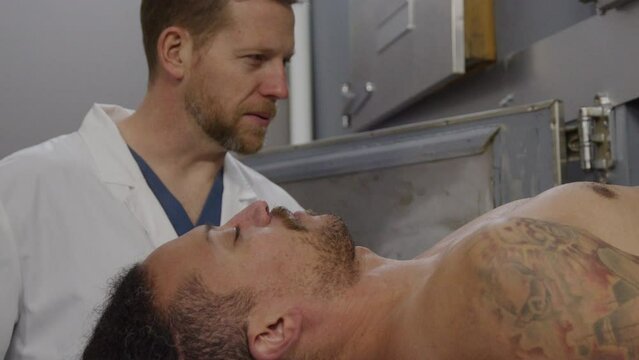 Medical examiner with corpse in a morgue scene