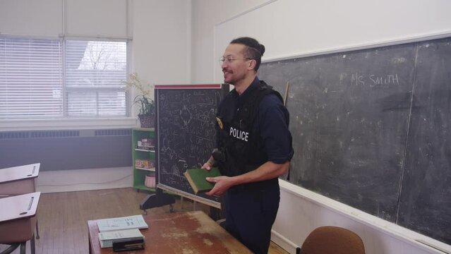 Smiling police officer in a school classroom