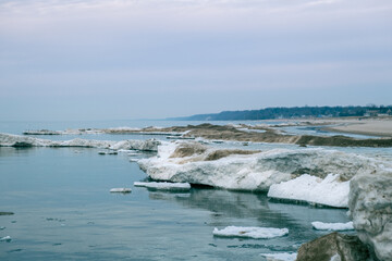 Ice dunes formed during winter in the lakeshore with Lake Michigan in background