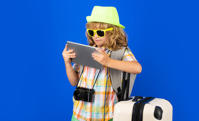 Child traveler with travel bag in studio. Kids tourism.