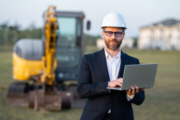 Worker in suit and helmet. Investor civil engineer, construction manager. Construction building developer at a construction site. Successful architect. Handsome hispanic builder man in suit.