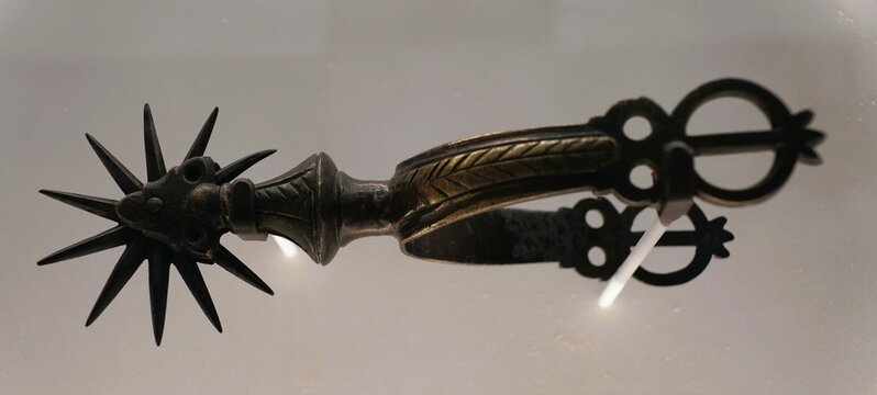 San Antonio, Texas, U.S.A - April 9, 2024 - The metal spur used on boots displayed inside of the Alamo Exhibit