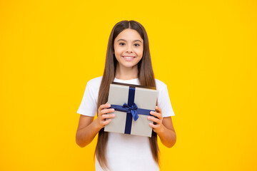 Happy teenager portrait. Teenager kid with present box. Teen girl giving birthday gift. Present, greeting and gifting concept. Smiling girl.