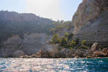 View of the rocky shore from the sea. Mediterranean Sea in Turkey. Popular tourist places....