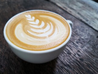 Latte art on brown wooden table