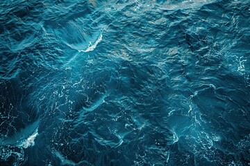 Fototapeta premium Top view of blue frothy sea surface. Shot in the open sea from above
