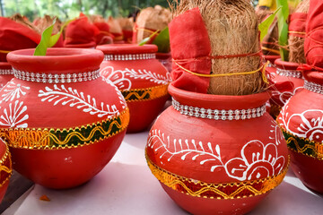 Kalash with coconut and mango leaf with floral decoration earthen pots containing sacred water. Kalash for hindu puja during Jagannath Temple Mangal Kalash Yatra, front view, closeup