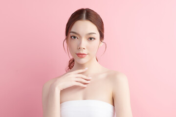 Naklejka premium Beautiful young asian woman with clean fresh skin on pink background, Face care, Facial treatment, Cosmetology, beauty and spa, Asian women portrait.